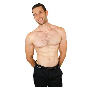 Sydney Premier Shirtless Host A smiling, shirtless male host for Sydney entertainment hire posing with his hands behind his back, providing premium event staffing and topless waiters for bachelorette parties and hens nights throughout Sydney, NSW.