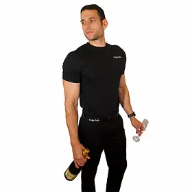 A professional male host for Sydney entertainment hire looking to the side while holding a bottle of champagne and an empty flute. He is wearing a black "Lucky Ladds" t-shirt and provides premium event staffing and topless waiters for hens parties and bachelorette events in Sydney, NSW.