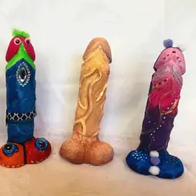 The "Tuxedo & Pink" Risqué Sculpture Trio A lineup of three creatively decorated phallic sculptures, including one with a blue "tuxedo" design and another in shimmering pink and purple, from a mobile "Design-a-Willy" workshop. These naughty risqué moulds are a popular choice for hens parties, birthdays, and lively celebrations available Australia-wide.