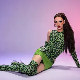 Ann Xiety Green Leopard Look Brisbane drag queen Ann Xiety posing in a green leopard-print outfit and matching boots during a professional studio photoshoot.