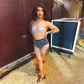 Perth drag queen Moesha posing in a silver mesh performance outfit before a show.