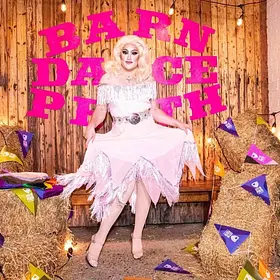 Delvira Barn Dance Queen Perth drag queen Delvira performing in a glamorous white costume at a colourful barn dance party, available to book for themed parties and private events.